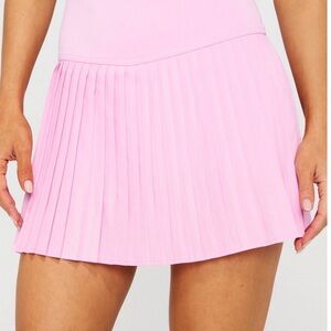 Fabletics Hot Shot Pleated Skort in the Pink Marshmallow color.